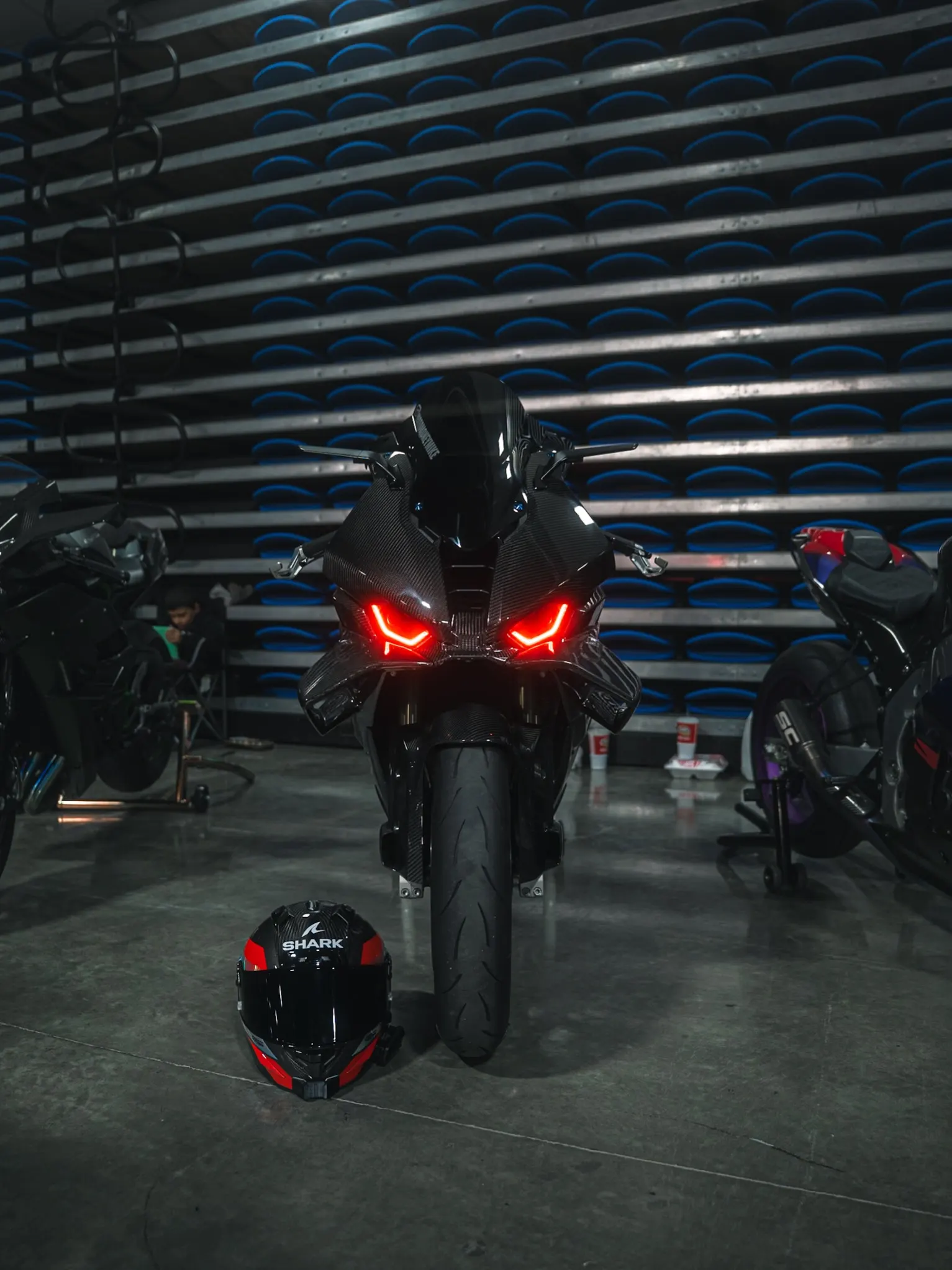 Mike's carbon fibre 2025 BMW S1000RR with glowing red lights, seen from the front